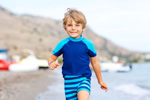 Little blond kid boy running ocean beach — Stock Photo, Image