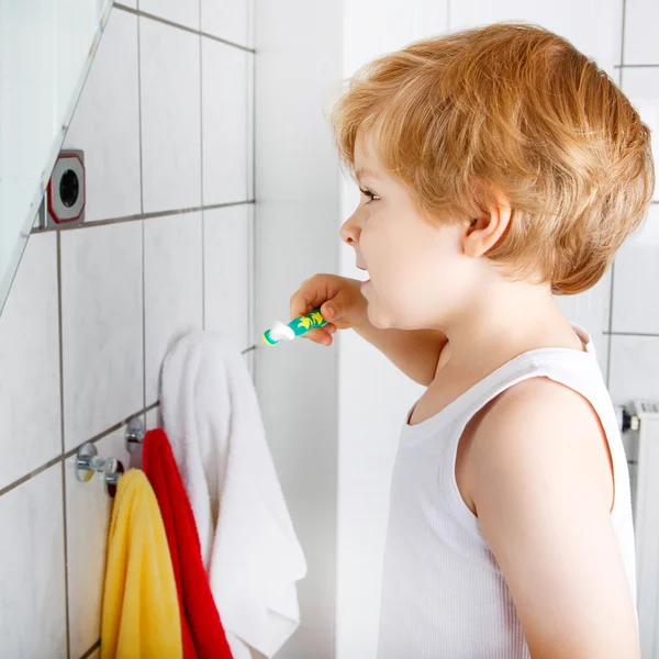 Lovely toddler boy brushing his teeth, indoors — Stock Photo, Image