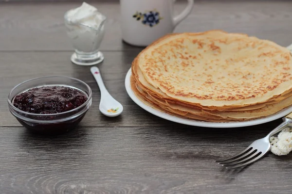 Stack of pancakes served with berry jam and sour cream — Stock Photo, Image