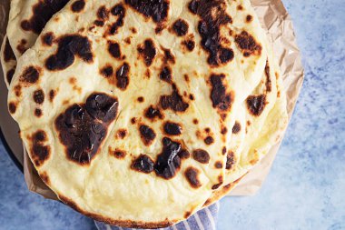 Bir yığın ev yapımı çıtır ekmek, mavi arka plan. Üst görünüm.