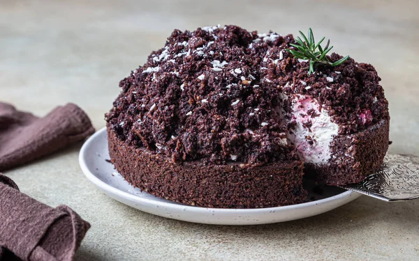 Homemade chocolate cake with cherry and whipped cream. Cake Mink mole or Mole hole cake. Selective focus.