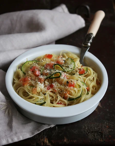 Spaghetti pasta dinner with tomatoes, courgette