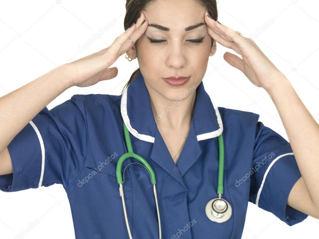 Stressed Young Doctor or Nurse Wortking Under Pressure