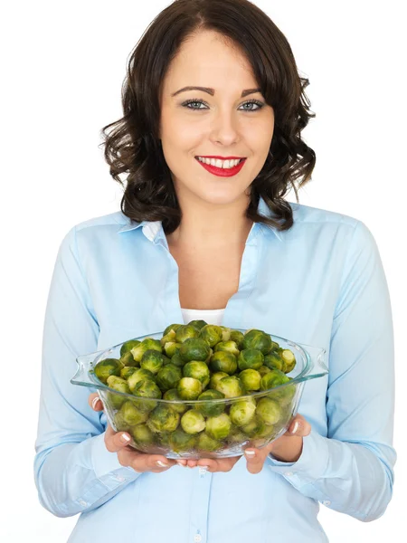 Young Woman Holding a Bowl of Brussels Sprouts — Stock Photo, Image