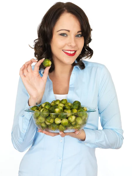 Young Woman Holding a Bowl of Brussels Sprouts — Stock Photo, Image