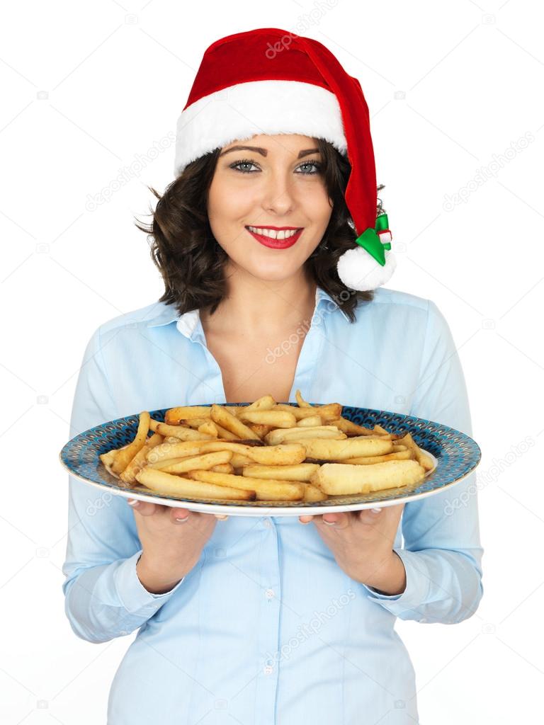 Young Woman in Santa Hat Holding a Plate of Roast Parsnips