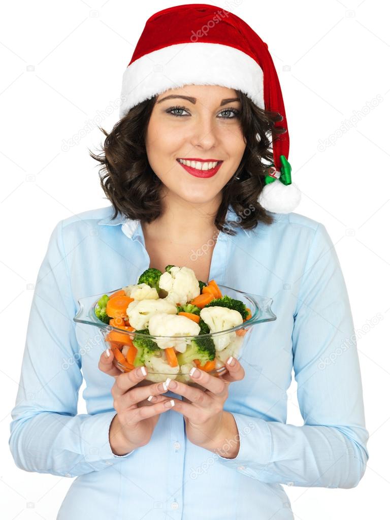 Young Woman in Santa Hat Holding Bowl of Cooked Mixed Vegetables