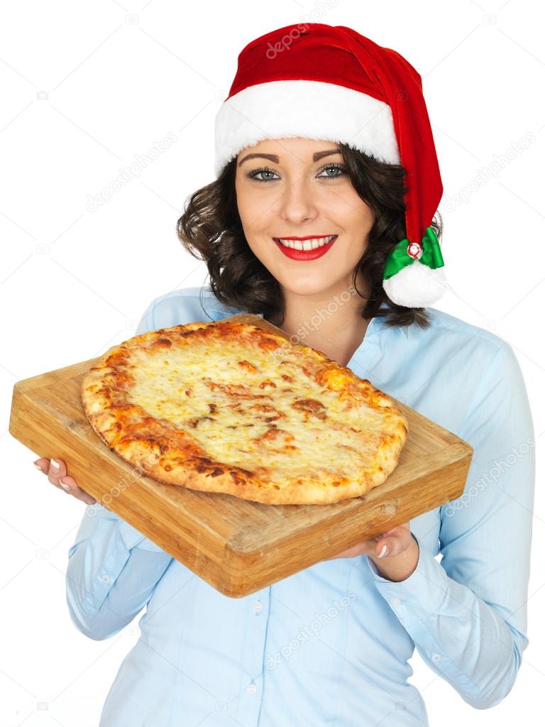Young Woman in Santa Hat Holding a Cooked Pizza