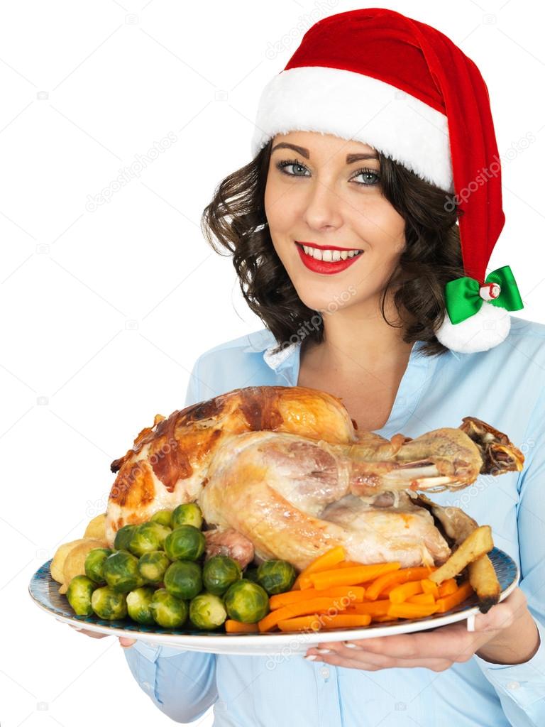 Young Woman in Santa Hat Holding Roast Turkey and Vegetables