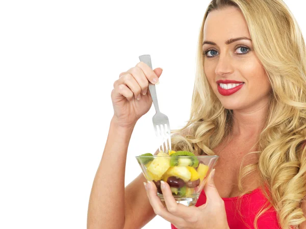 Jovem mulher comendo salada de frutas frescas — Fotografia de Stock