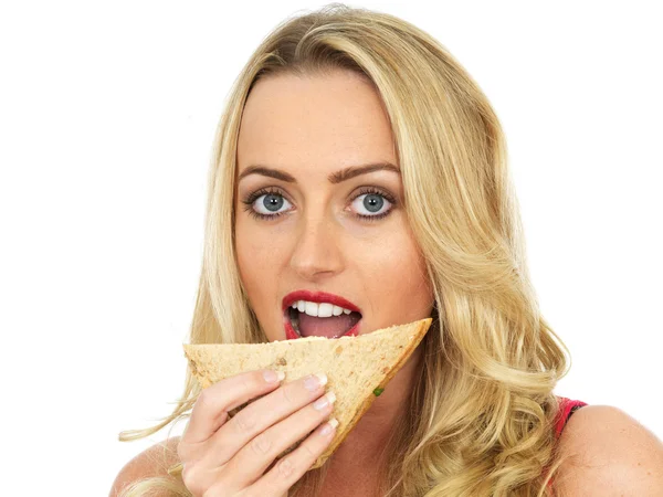 Mujer joven comiendo un sándwich — Foto de Stock
