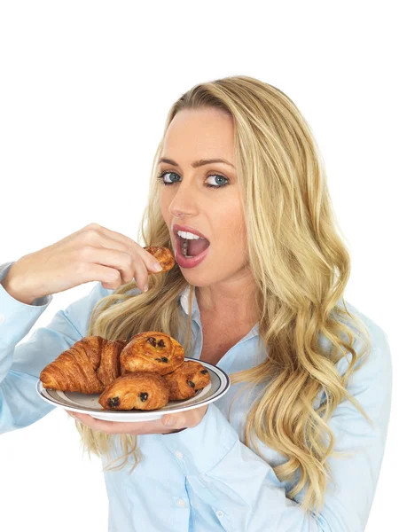 Mladá žena jíst dánské pečivo — Stock fotografie
