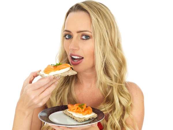 Young Woman Eating Smoked Salmon and Cream Cheese on a Cracker — Stock Photo, Image