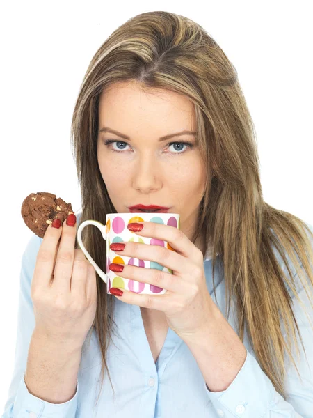 Jovem mulher desfrutando de chá e biscoitos — Fotografia de Stock