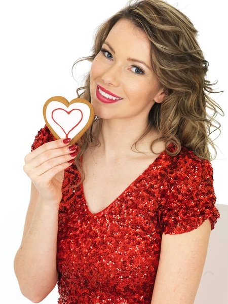 Joven sosteniendo galletas de jengibre de San Valentín — Foto de Stock
