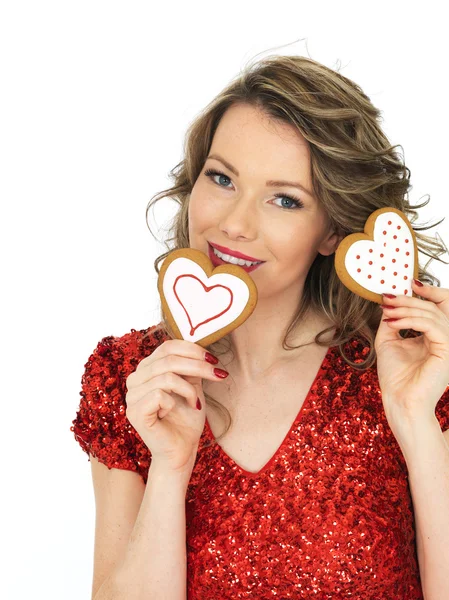 Joven sosteniendo galletas de jengibre de San Valentín — Foto de Stock