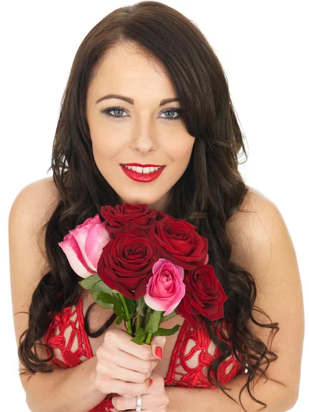 Sexy junge Frau trägt rote Dessous und rote Rosen — Stockfoto