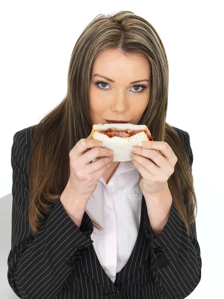 Young Business Woman Eating a Bacon Sandwich — Stock Photo, Image