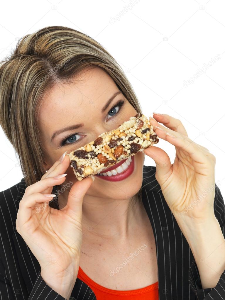 Young Business Woman Eating a Breakfast Cereal Bar