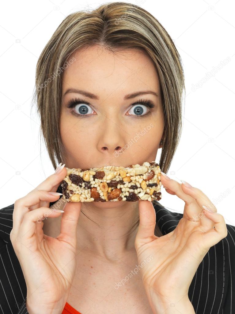 Young Business Woman Eating a Breakfast Cereal Bar