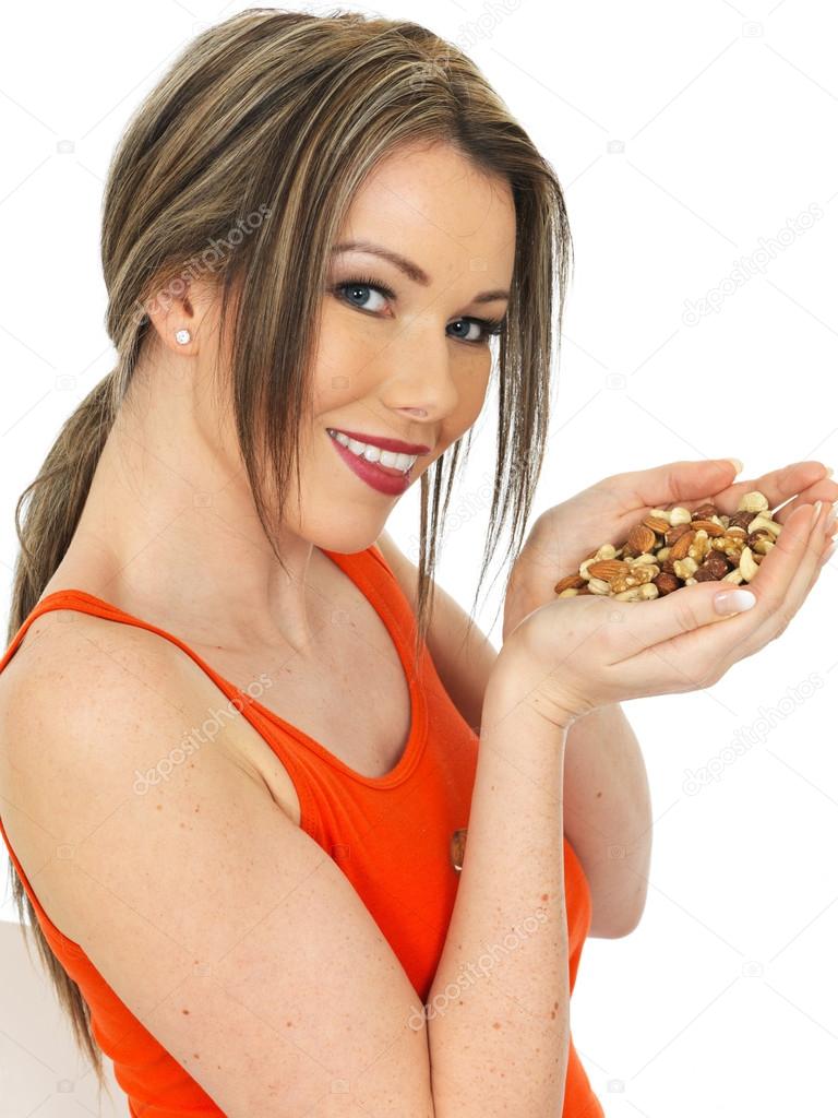 Young Woman Holding a Handful of Mixed Nuts