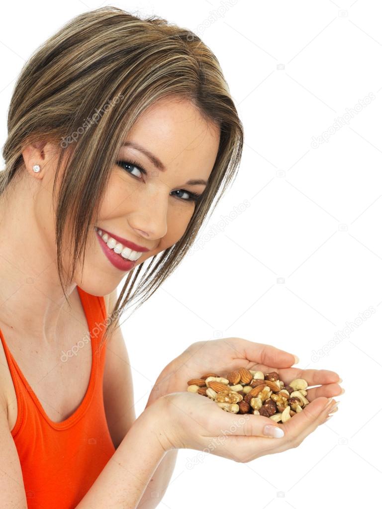 Young Woman Holding a Handful of Mixed Nuts