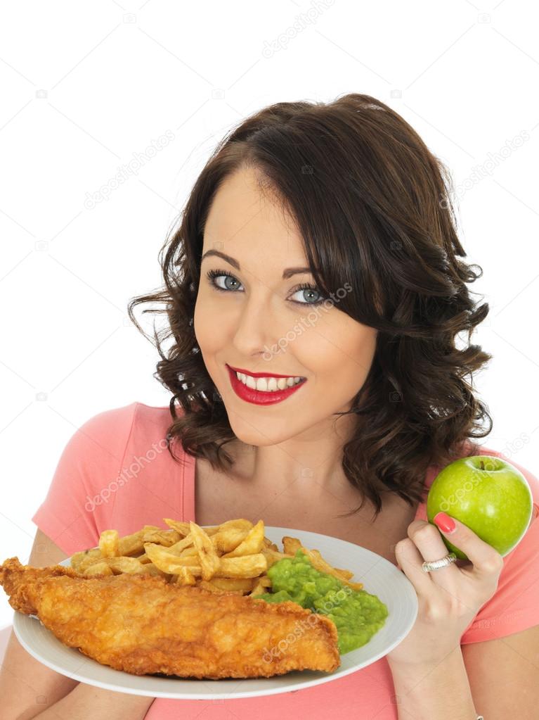 Young Woman Eating Fish and Chips with Mushy Peas