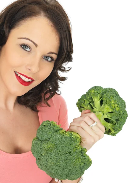 Mujer joven sosteniendo brócoli crudo — Foto de Stock