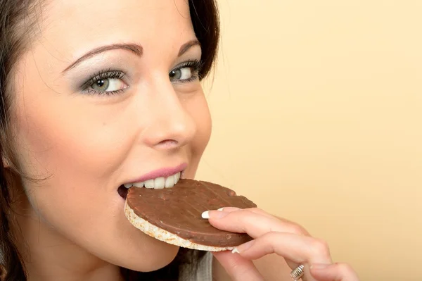 Young Woman Eating Chocolate Covered Rice Cakes — Stock Photo, Image