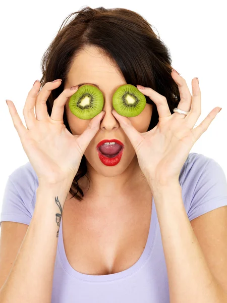 Shocked Young Woman Covering Eyes with Kiwi Fruit — Stock Photo, Image