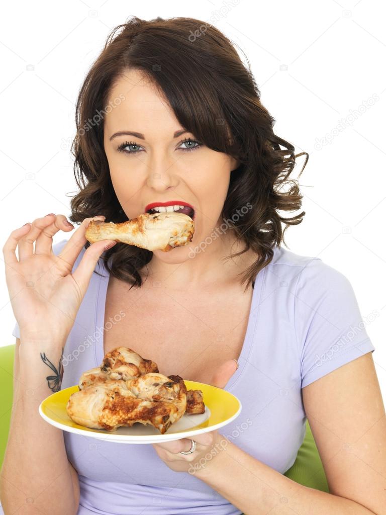 Young Woman Eating Cold Cooked Chicken Legs