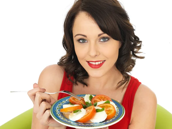 Young Woman Eating a Mozzarella Cheese and Tomato Salad — Stock Photo, Image