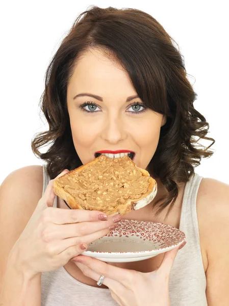Young Woman Holding Toast with Crunchy Peanut Butter — Stock Photo, Image