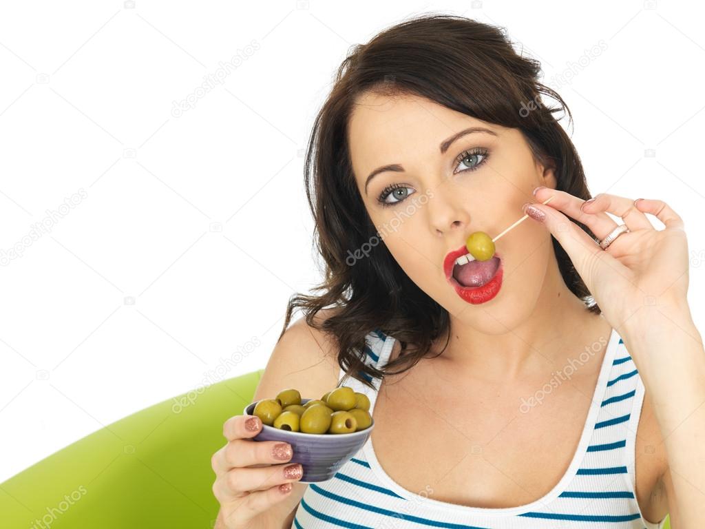 Young Woman Eating Green Olives