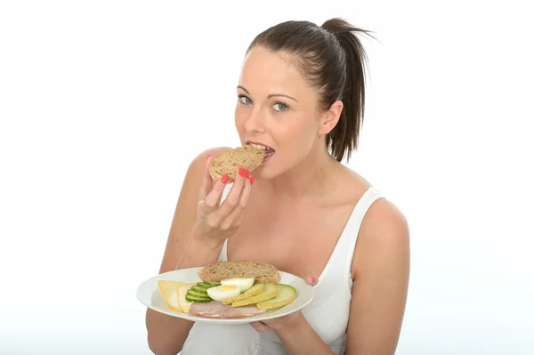 Gezonde jonge vrouw met een bord van een typisch gezond Scandinavisch ontbijtbuffet — Stockfoto