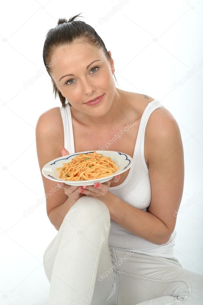 Attractive Healthy Young Woman Holding A Plate Of Freshly Cooked Italian Spaghetti