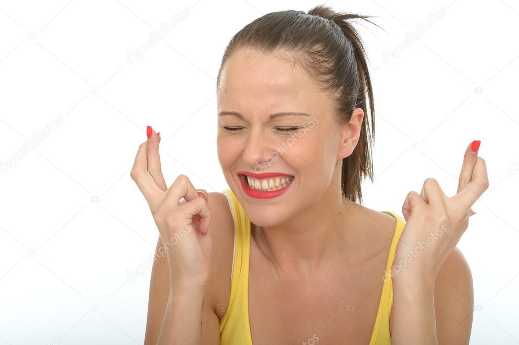 Portrait of a Happy Young Woman With Her Fingers Crossed