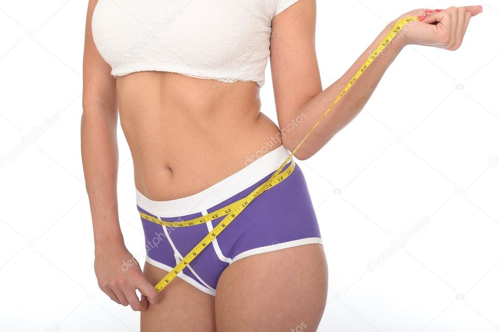 Healthy Young Woman Checking Her Weight Loss With a Tape Measure