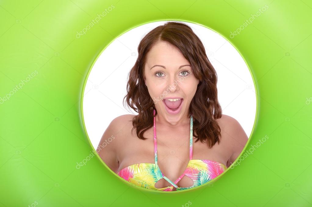 Sexy Young woman Looking Through a Rubber Swimming Ring