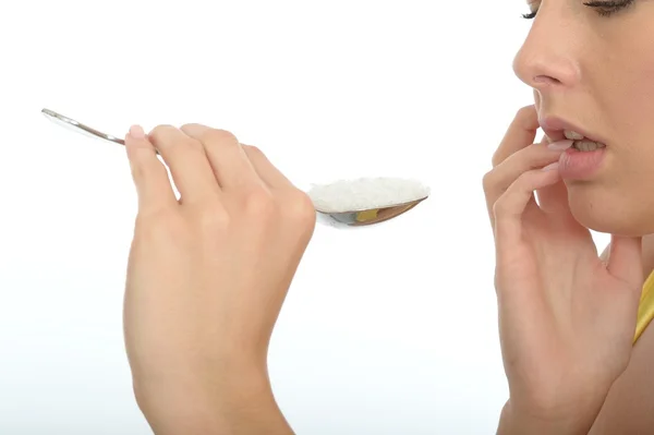 Attractive Young Woman Holding a Spoonful of Salt — Stock Photo, Image