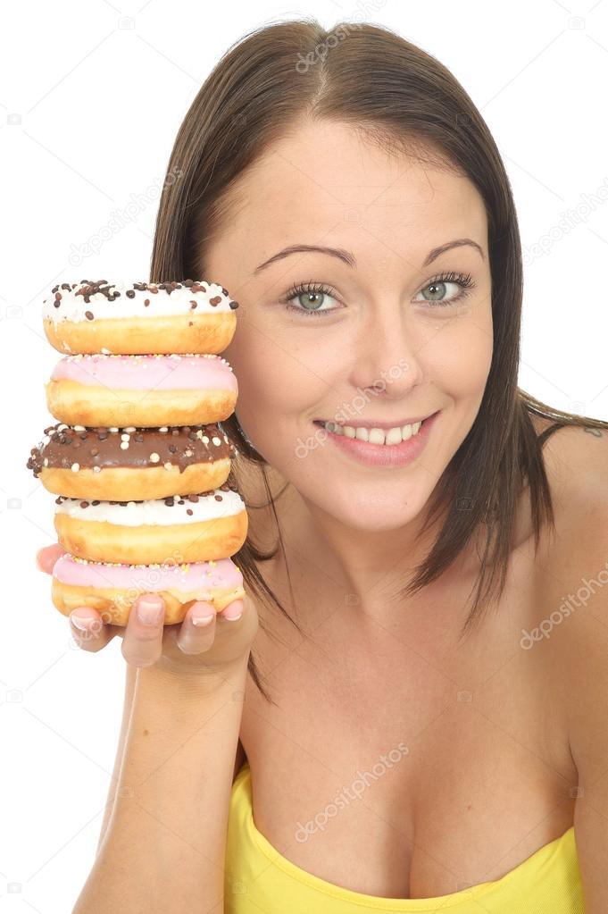 Attractive Young Woman Holding a Pile of Iced donuts