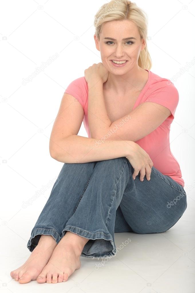 Happy Thoughtful Young Woman Sitting on the Floor Relaxing