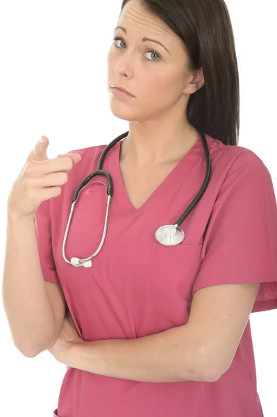 Portrait Of A Beautiful Young Female Doctor Pointing And Looking Stock Image