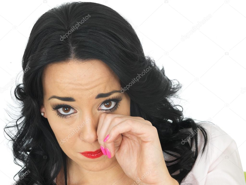 Portrait of a Beautiful Young Hispanic Woman Wiping Her Eye Looking Upset