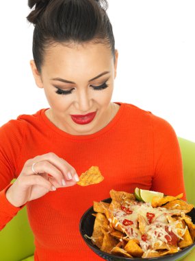 Beautiful Young Hispanic Woman With a Plate of Cheesy Nachos and Spicy Salsa Sauce