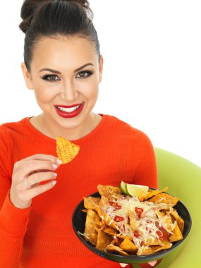 Beautiful Young Hispanic Woman With a Plate of Cheesy Nachos and Spicy Salsa Sauce