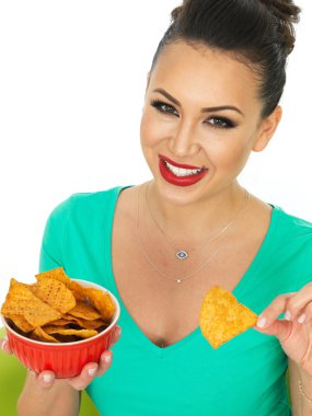 Beautiful Attractive Young Hispanic Woman Holding A Bowl Of Spicy Tortilla Chips