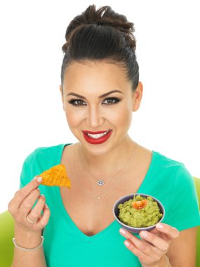 Beautiful Young Hispanic Woman Holding A Small Bowl Of Homemade Guacamole