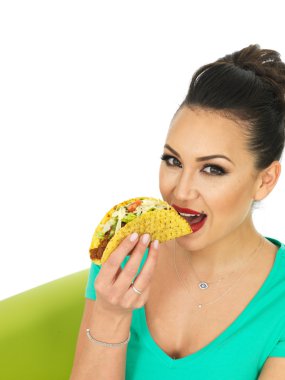 Beautiful Young Hispanic Woman With Crispy Chilli Beef Tacos with Salad and Grated Cheese