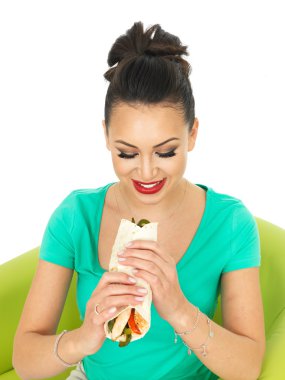 Beautiful Attractive Young Hispanic Woman With A Chicken Fajita Wrap and Sliced Peppers